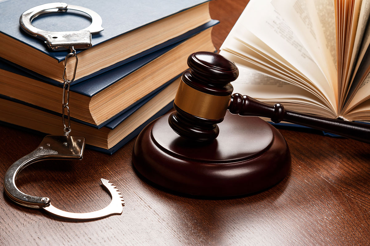 judge gavel, law books and handcuffs